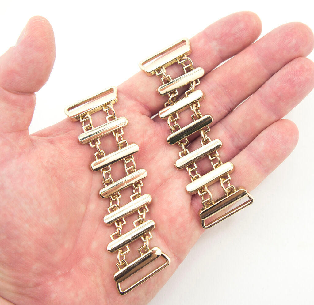 Set of 2 gold tone metal embellishments, 100 mm size.