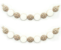 Gold tone metal circular design chain with white enamel.
