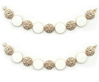 Gold tone metal circular design chain with white enamel.