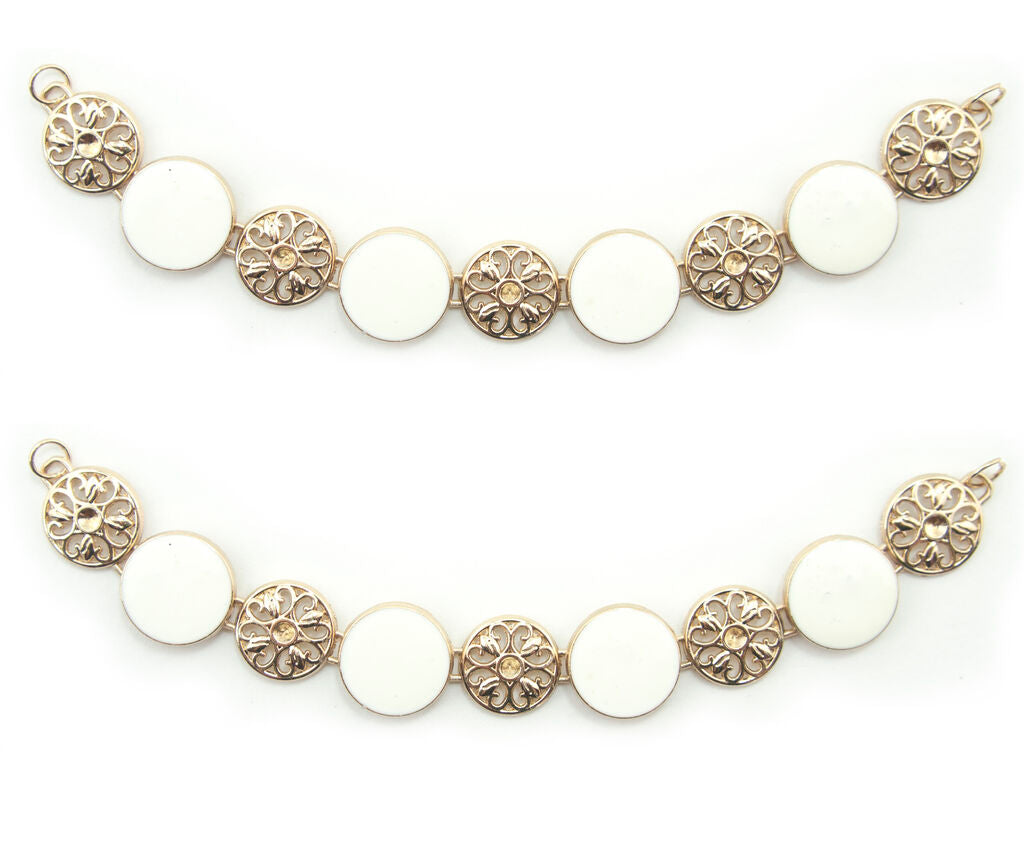 Gold tone metal circular design chain with white enamel.