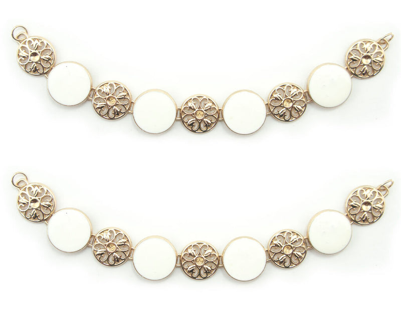 Gold tone metal circular design chain with white enamel.