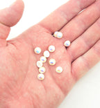 Close-up of an 8 mm pearlescent round trim with a metal pin backing.