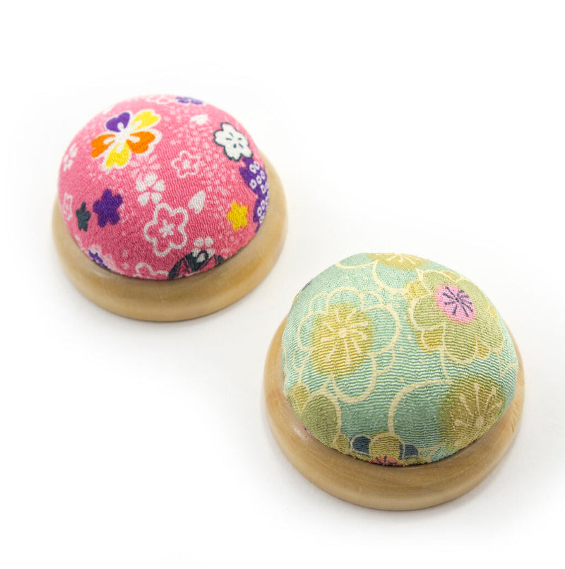 Round pin cushion with Japanese Kiwa wood base and floral pattern.