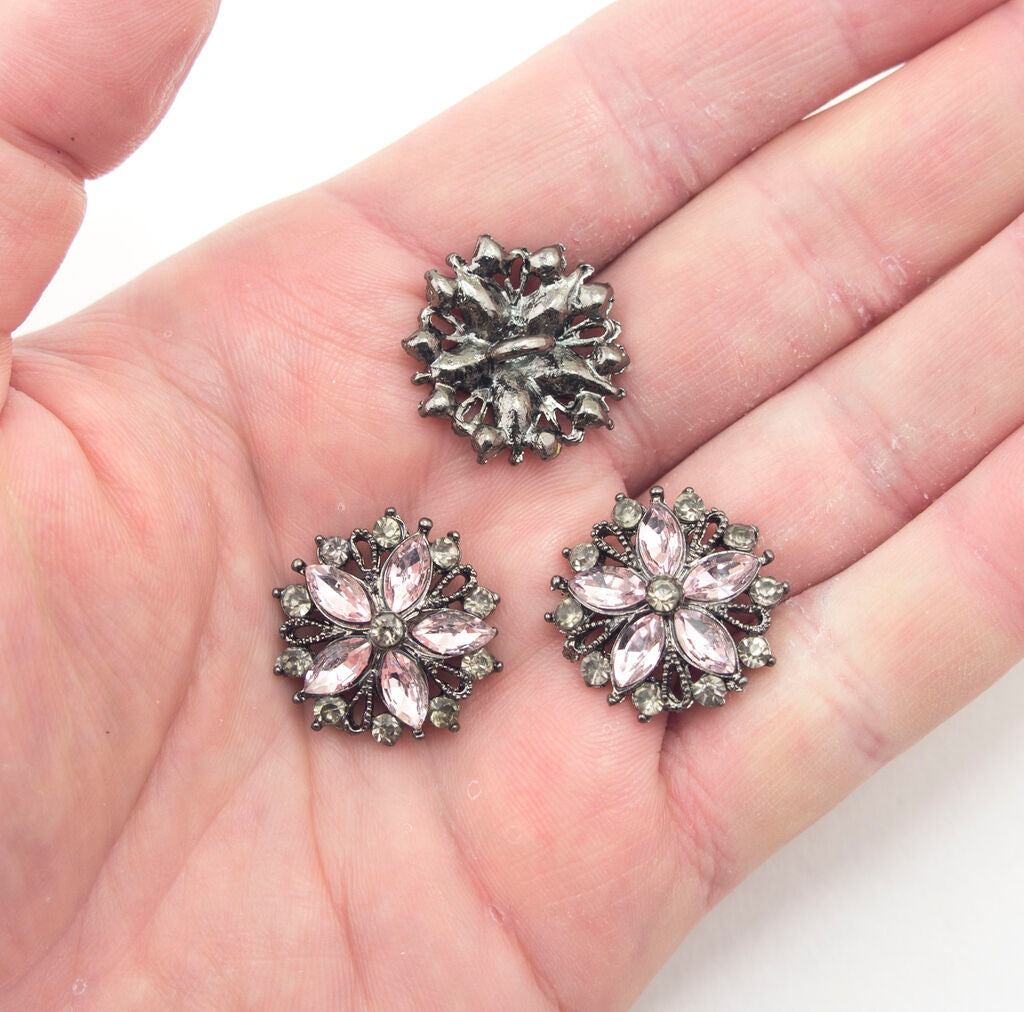 Close-up of a light pink glass crystal button, 24 mm diameter, showcasing its vintage design.