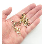 Gold-tone lobster claw clasp attached to a piece of jewellery