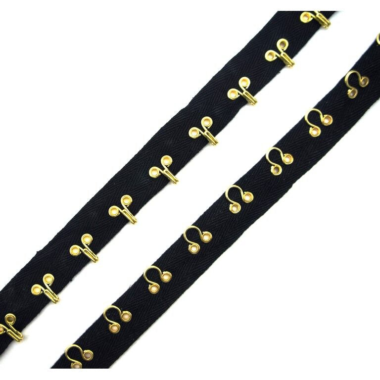 Continuous gold-tone metal hooks and eyes on black cotton tape