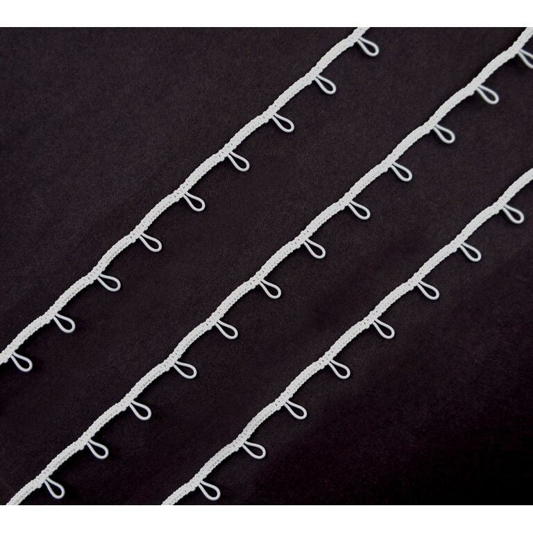 White button looping displayed on a measuring tape for size reference.