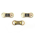Gold-tone pin on embellishments featuring a serpentine S design.