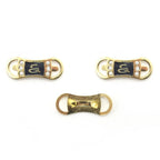 Gold-tone pin on embellishments featuring a serpentine S design.
