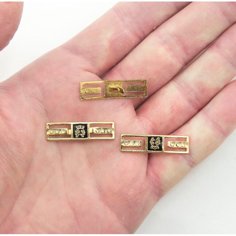 Set of five gold-tone crown trims for shoes and accessories.