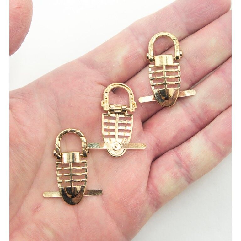 Close-up of gold-tone metal embellishments, 36 mm size.