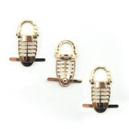 Gold-tone trilobite pin on embellishments for leather goods.