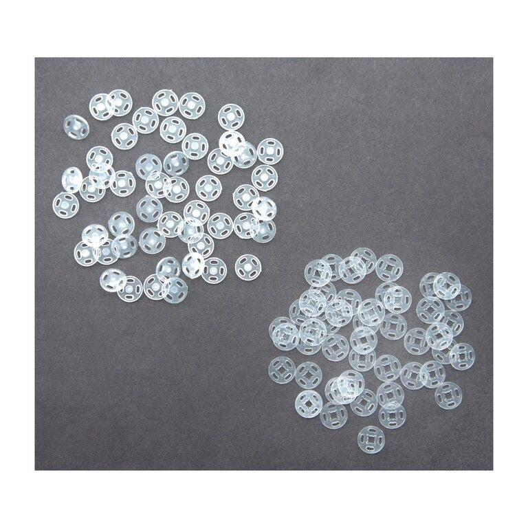 Clear plastic press stud buttons displayed on a white background.