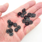 Close-up of 12 mm black plastic press stud buttons for sewing.