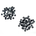 Set of black plastic press stud buttons displayed in packaging.