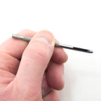 Close-up of a leather punch making a hole in a leather strap.