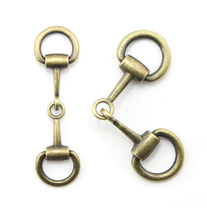 Antique gold equestrian buckle displayed on a white background.