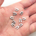 Close-up of metal ends designed for use with spiral steel boning.