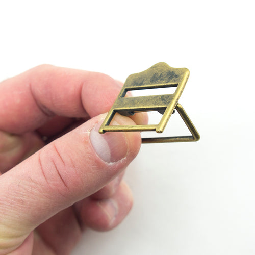 Close-up of antique gold tone metal buckle, size 30 x 29 mm