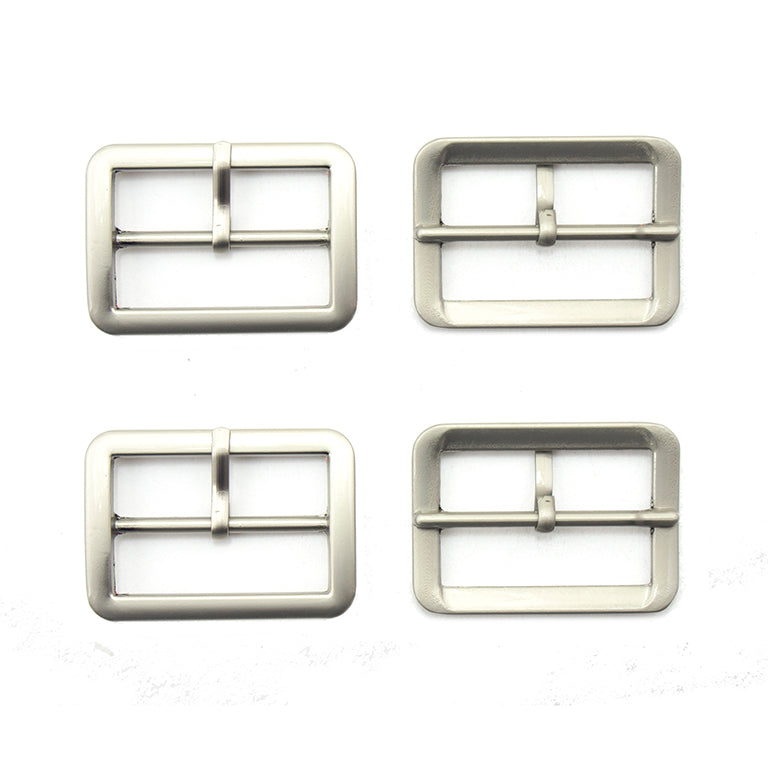 Four silver tone metal buckles displayed on a white background.