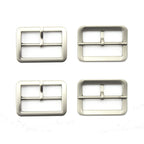 Four silver tone metal buckles displayed on a white background.