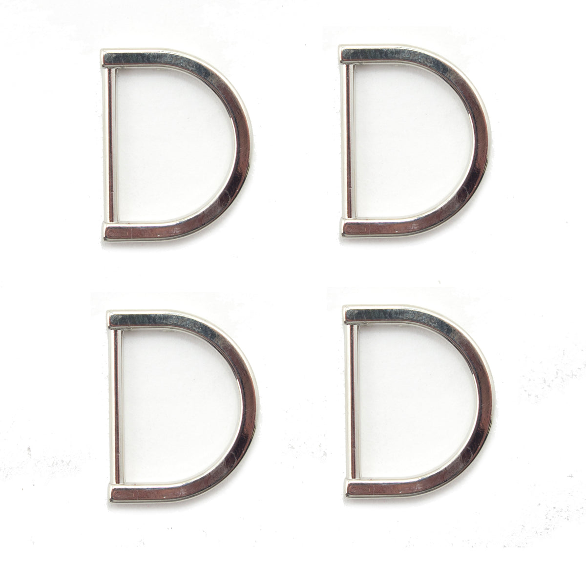 Four silver tone metal D rings displayed on a white background.