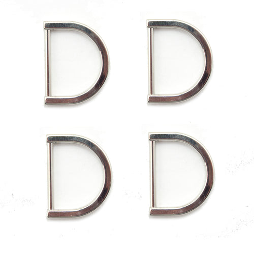 Four silver tone metal D rings displayed on a white background.