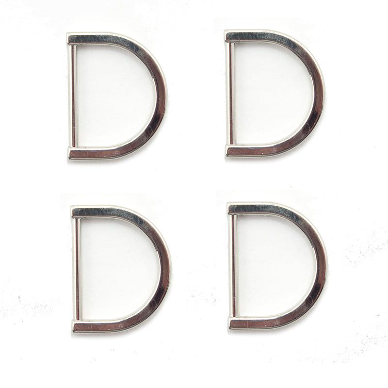 Four silver tone metal D rings displayed on a white background.