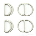 Four silver tone metal hinged D rings on a white background.