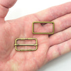Close-up of an antique gold tone 2-part metal buckle for accessories.