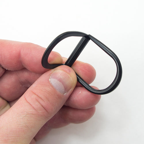 Close-up of black metal D ring showing its 2-part locking mechanism.