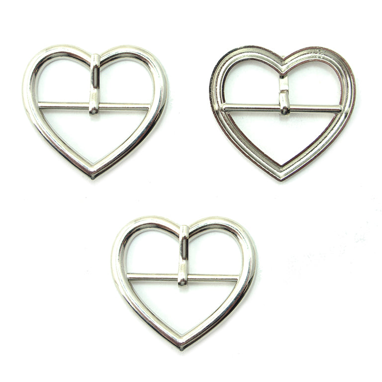 Three silver tone metal heart shaped buckles for accessories.
