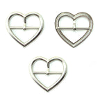 Three silver tone metal heart shaped buckles for accessories.