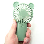 Compact fan in a travel-friendly design, ideal for summer heat relief.