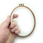 Small wood-effect oval embroidery hoop measuring 12 x 9.5 cm