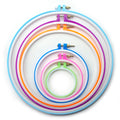 Set of six colourful circular plastic embroidery hoops