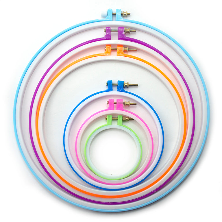 Set of six colourful circular plastic embroidery hoops
