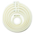Six cream circular plastic embroidery hoops of various sizes.