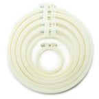 Six cream circular plastic embroidery hoops of various sizes.