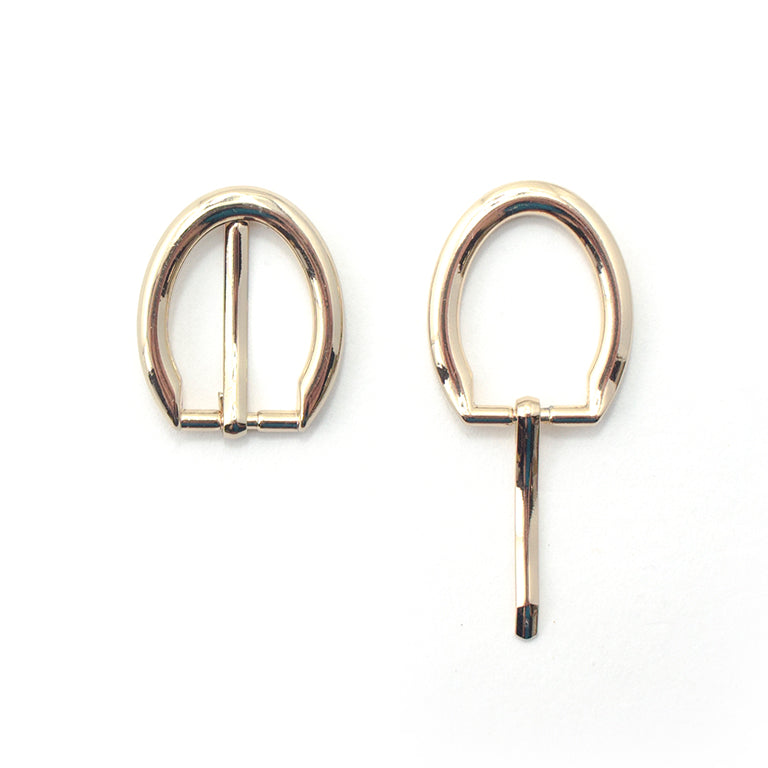 Gold tone oval metal buckle suitable for shoes and bags.