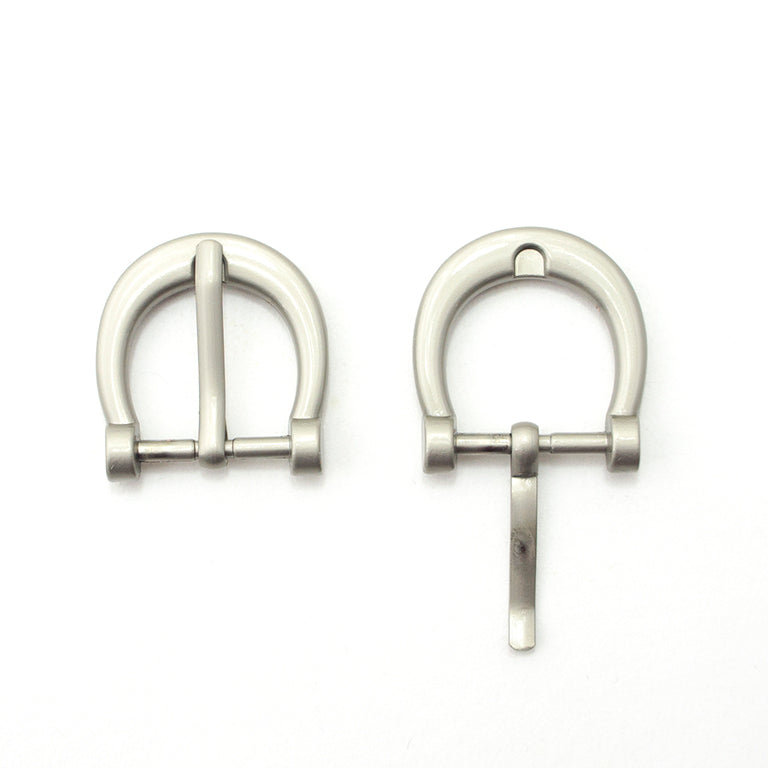 Pale grey horseshoe shaped metal buckle for bags and belts.