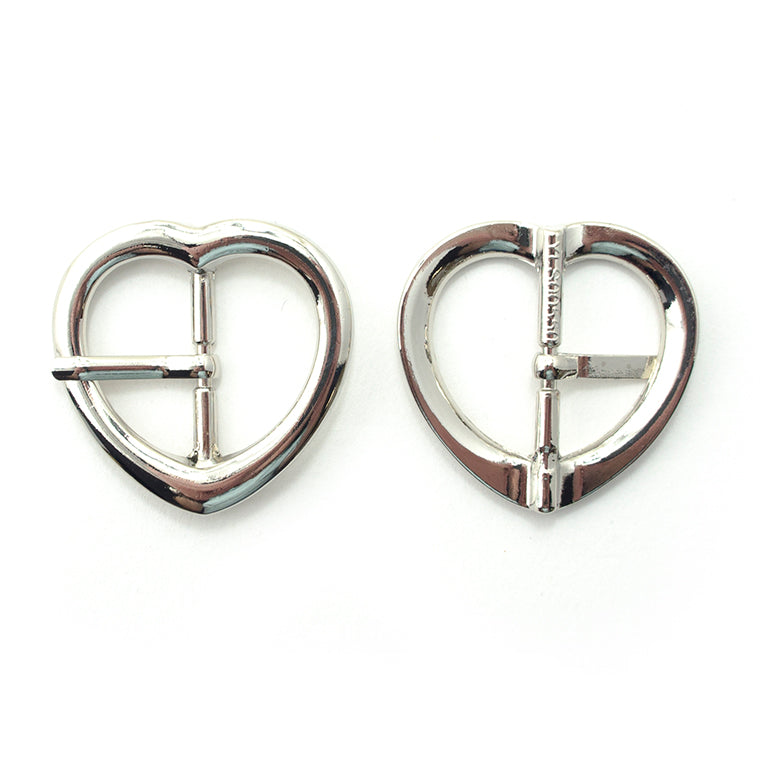 A pair of silver tone metal heart-shaped buckles for accessories.