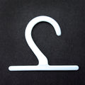 Pack of 48 small white plastic hangers for fabric samples.