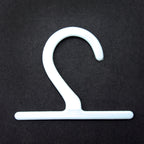 Pack of 48 small white plastic hangers for fabric samples.