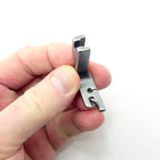 Hemming foot attached to an industrial sewing machine