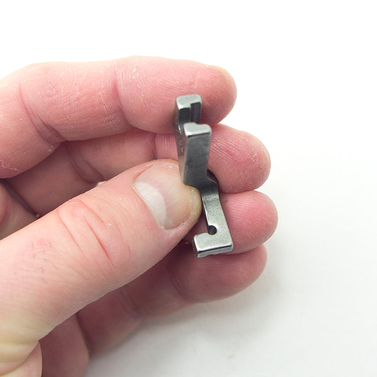 T168 presser foot alongside various sewing tools and materials