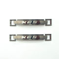 Dark gunmetal tone metal equestrian buckle with 'XES' logo.