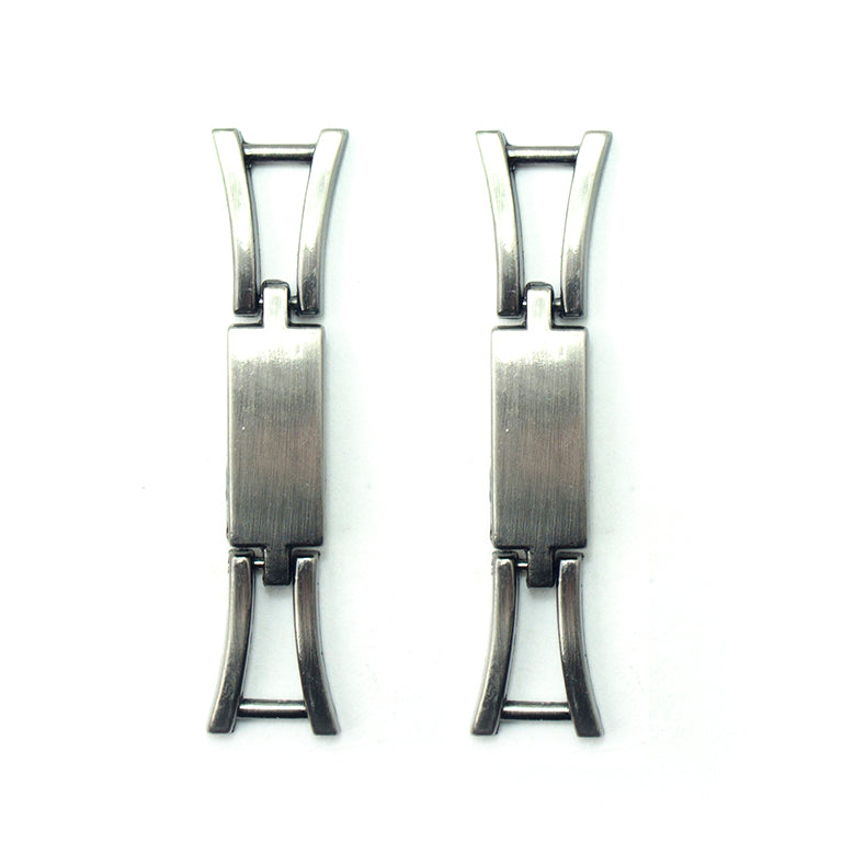 Polished gunmetal tone equestrian buckle on a white background.