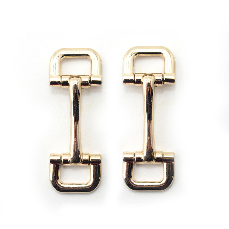 Gold tone square metal equestrian buckle on a white background.