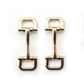 Gold tone square metal equestrian buckle on a white background.
